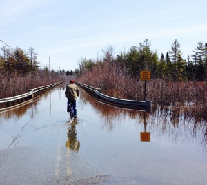 Spring thaws flood the causeway to Pushaw Lake in Maine.